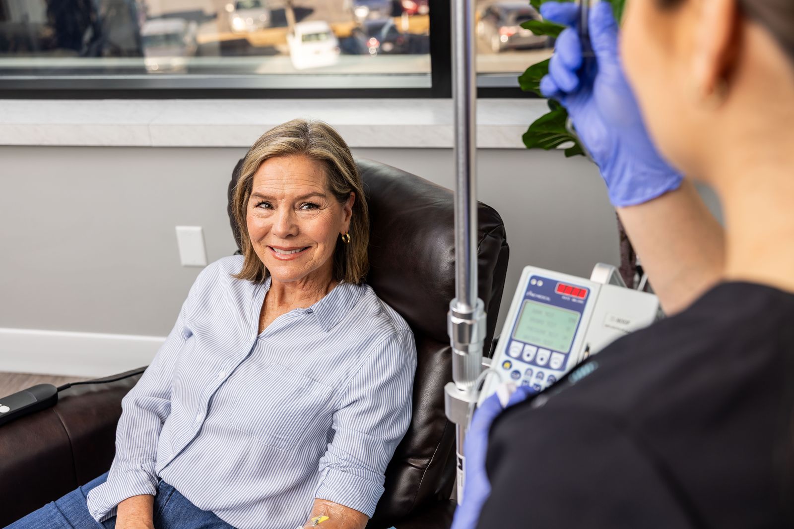 A patient talking with a nurse during treatment